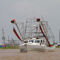 Fishing Boat Rigged with Oil Boom
